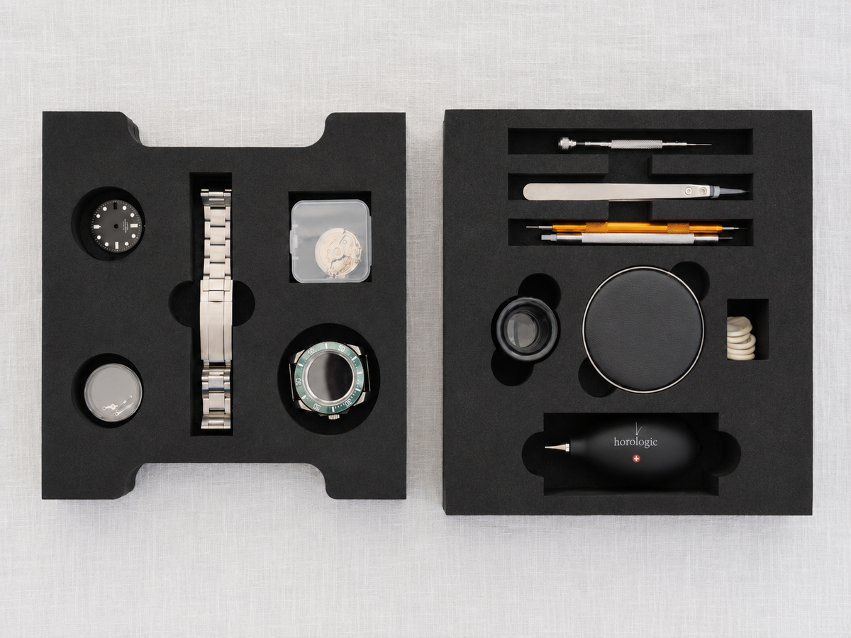Sportsman watch components and assembly tools laid out in their inserts